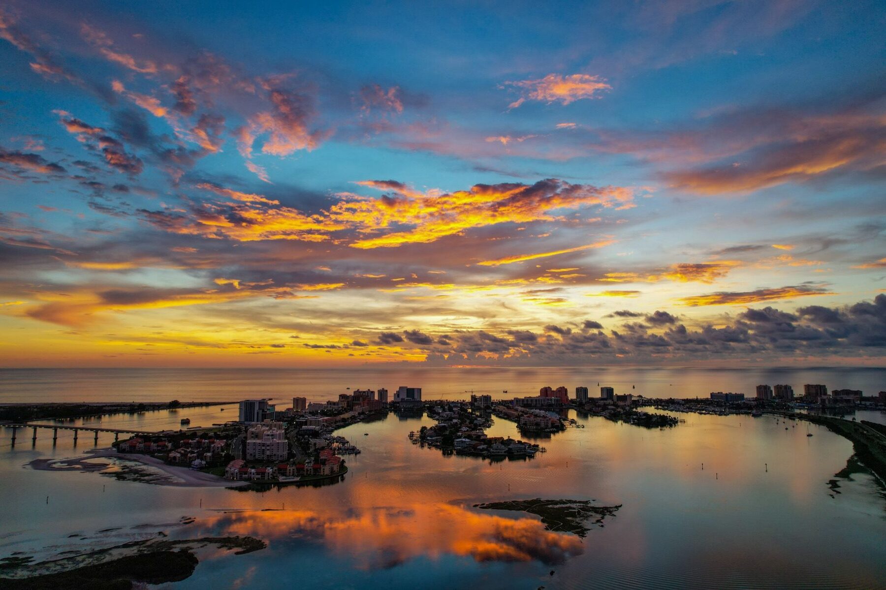 Aerial view of a golden Gulf Coast sunset over the barrier islands and waterways of Pinellas County